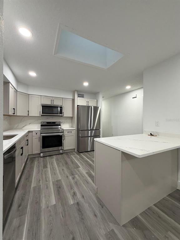 731 Bongart Road Winter Park, FL 32792 - Photo 16 of 28 a large kitchen with a center island and stainless steel appliances