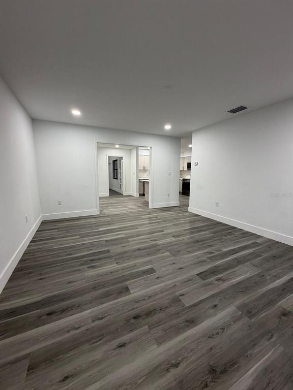 731 Bongart Road Winter Park, FL 32792 - Photo 5 of 28 an empty room with wooden floor and windows