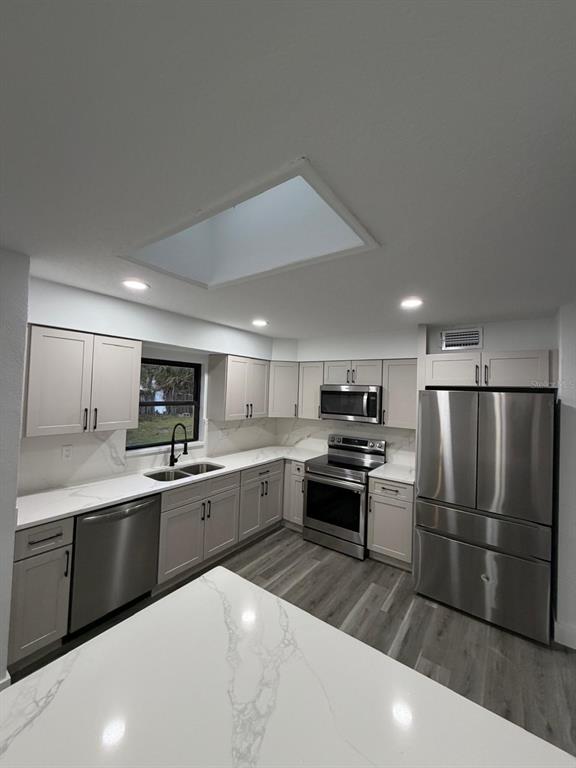 731 Bongart Road Winter Park, FL 32792 - Photo 8 of 28 a kitchen with granite countertop a sink stainless steel appliances and cabinets