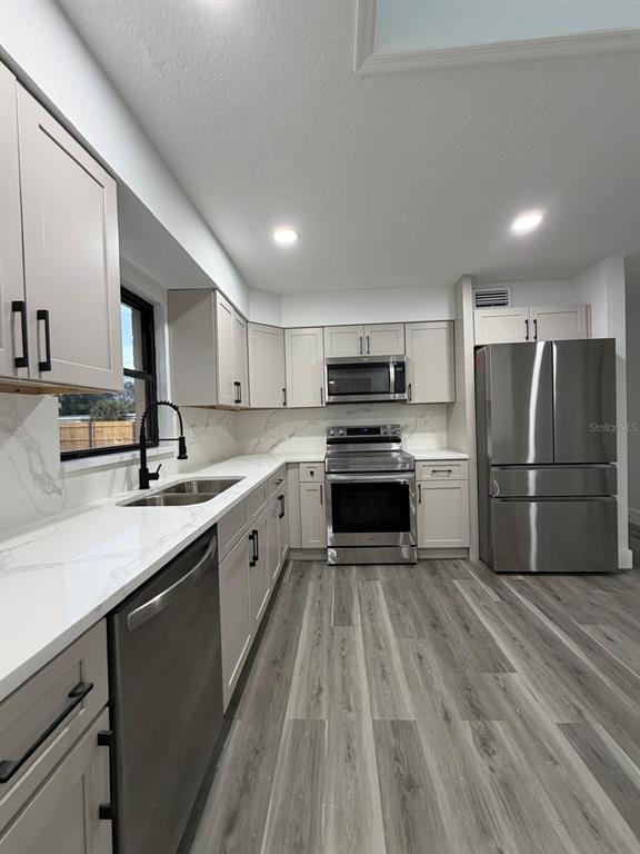 731 Bongart Road Winter Park, FL 32792 - Photo 9 of 28 a large kitchen with a sink stainless steel appliances and cabinets