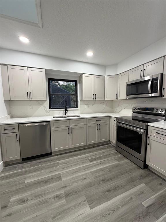 731 Bongart Road Winter Park, FL 32792 - Photo 10 of 28 a kitchen with stainless steel appliances a sink and a stove top oven