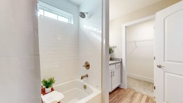 a bathroom with a bathtub and a shower