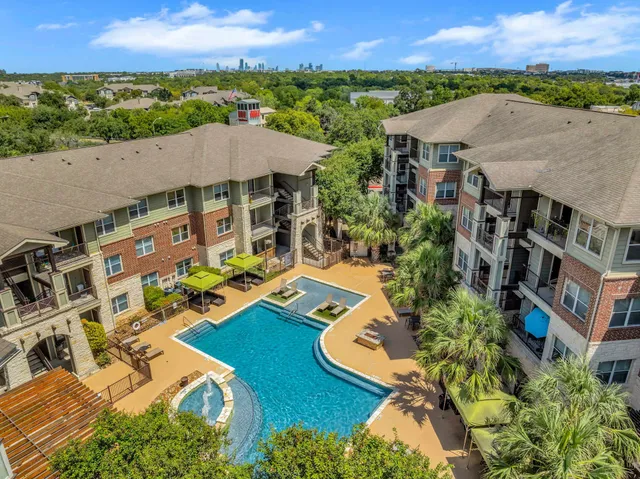 an aerial view of multiple houses with a yard
