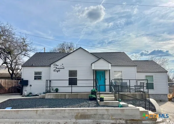 a view of a white house with a outdoor space