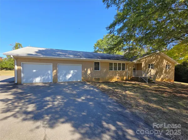 a view of a house with a yard and garage