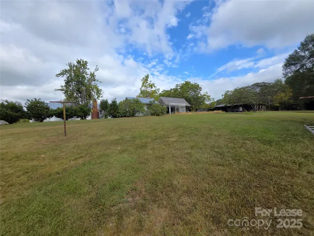 a view of a field with an trees