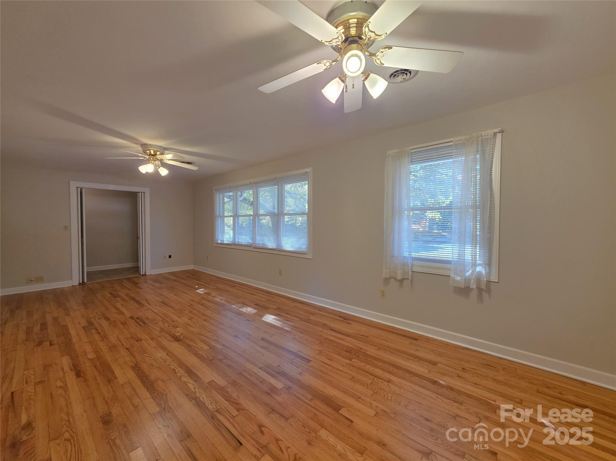 9301 Gold Hill Road Mount Pleasant, NC 28124 - Photo 4 of 32 a view of an empty room with a window and wooden floor
