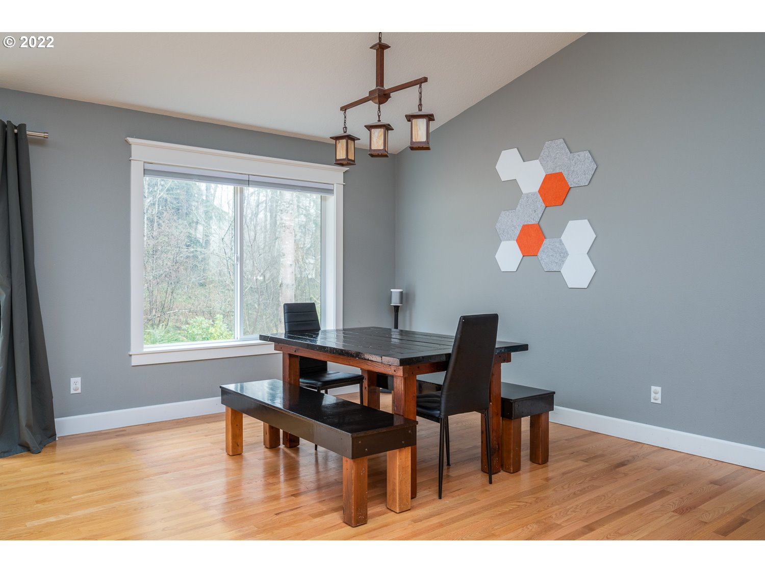 686 Eufaula Heights Road Longview, WA 98632 - Photo 11 of 29 a dining room with wooden floor a chandelier a wooden table and chairs