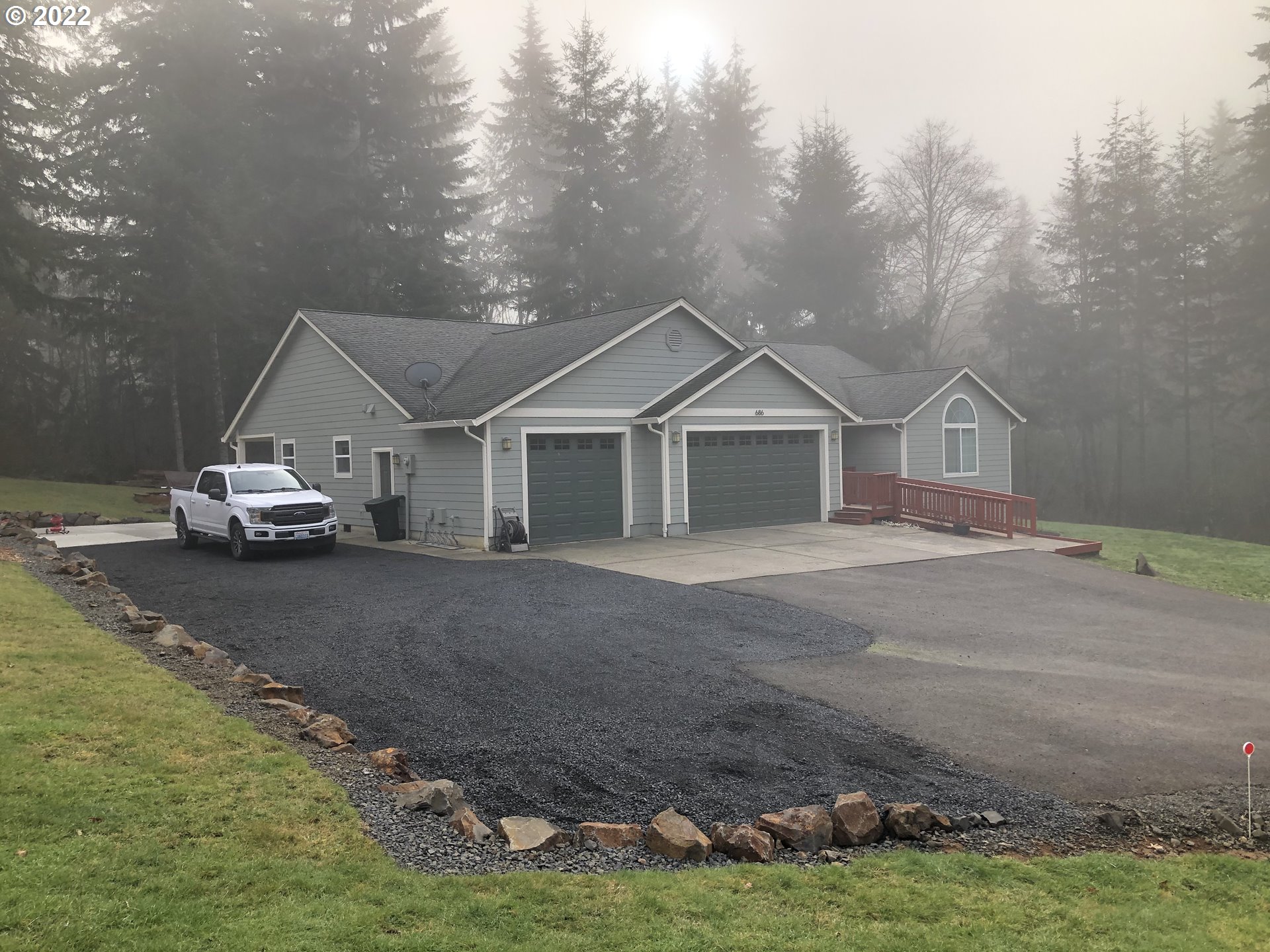 686 Eufaula Heights Road Longview, WA 98632 - Photo 2 of 29 a white house with a big yard and large trees