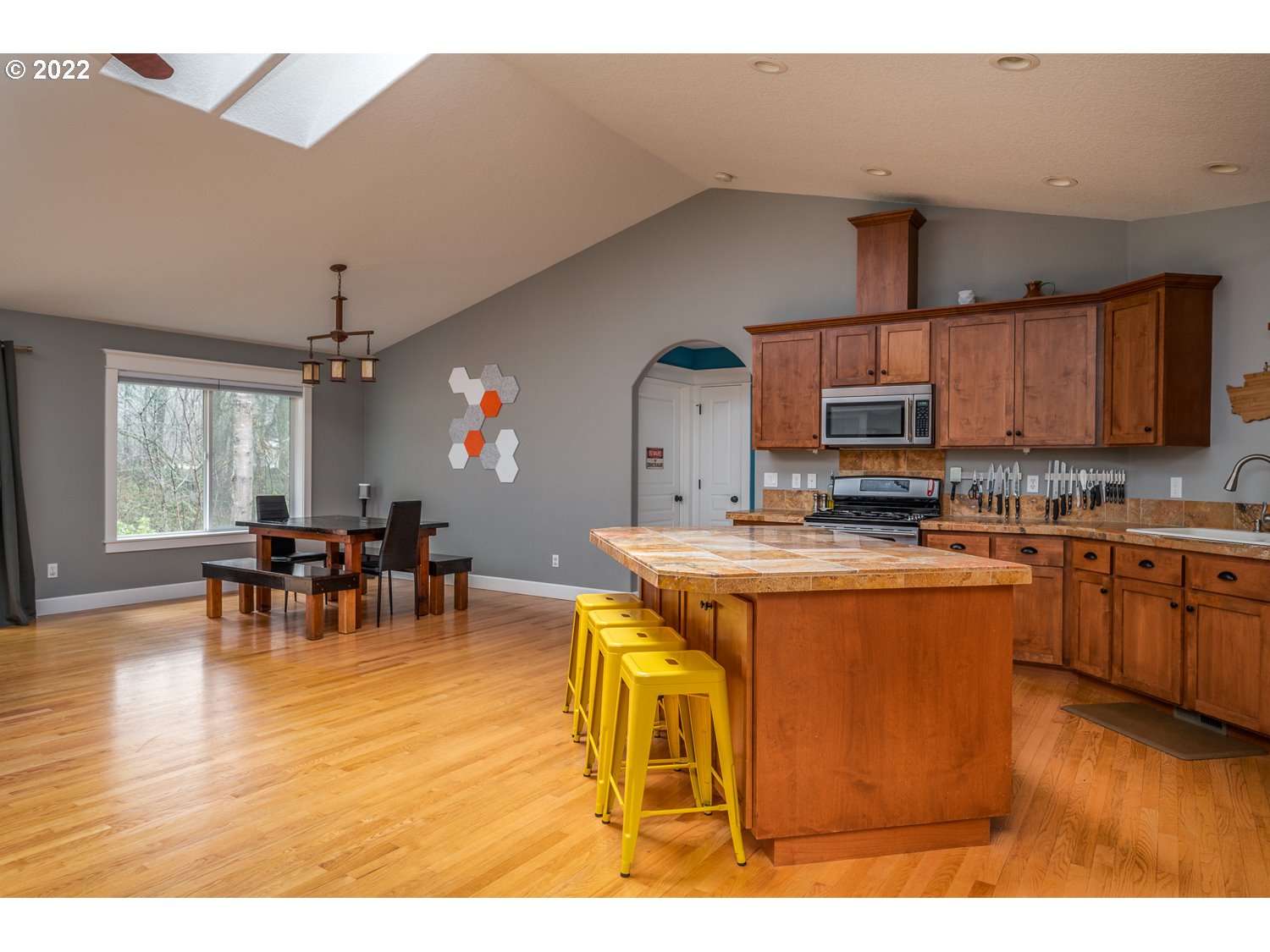 686 Eufaula Heights Road Longview, WA 98632 - Photo 6 of 29 a kitchen with stainless steel appliances kitchen island granite countertop a table chairs and a refrigerator