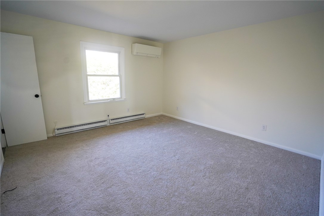 8746 Grubbs-Rex Road Arcanum, OH 45304 - Photo 3 of 38 This spacious bedroom offers ample natural light and plush carpeting for comfort.