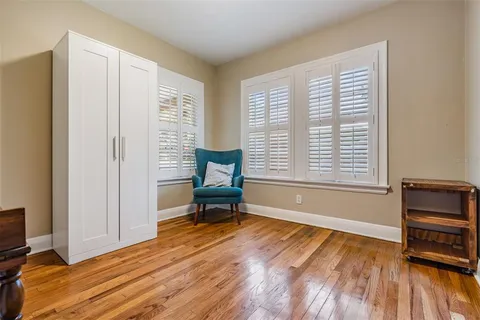 a view of room with window and wooden floor