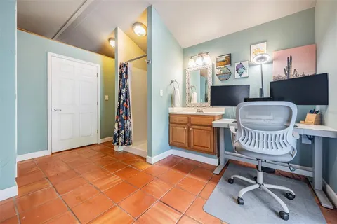 a bedroom with furniture and a workspace