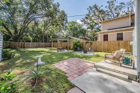 a view of backyard with a garden and trees
