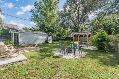 a view of a chair and table in backyard of the house