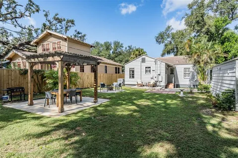 a front view of a house with a yard table and chairs