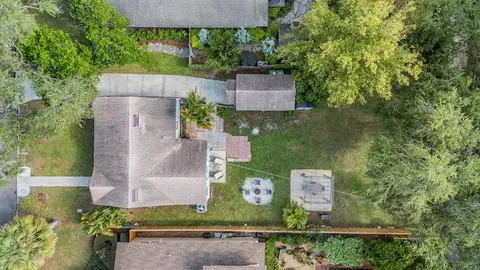 an aerial view of a house with a yard