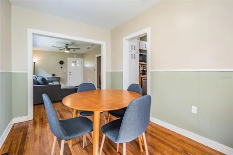 a view of a dining room with furniture and wooden floor