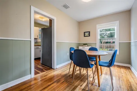 a view of a dining room with furniture and wooden floor