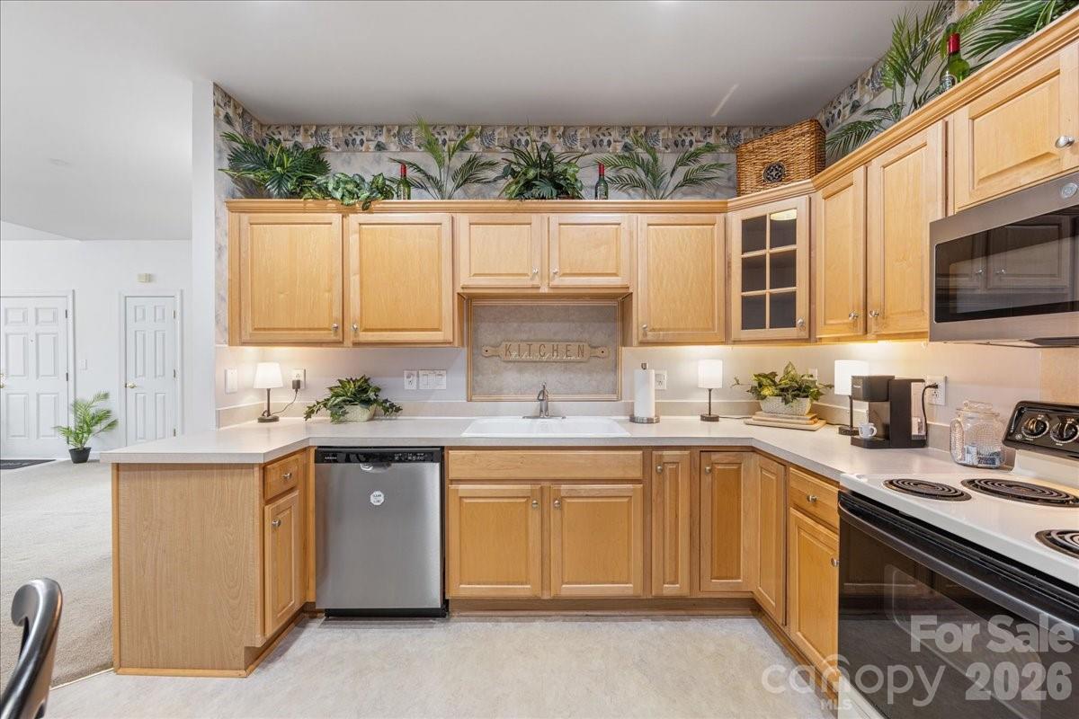 8368 Windsor Ridge Drive Charlotte, NC 28277 - Photo 19 of 46 a kitchen with a sink stove top oven and cabinets