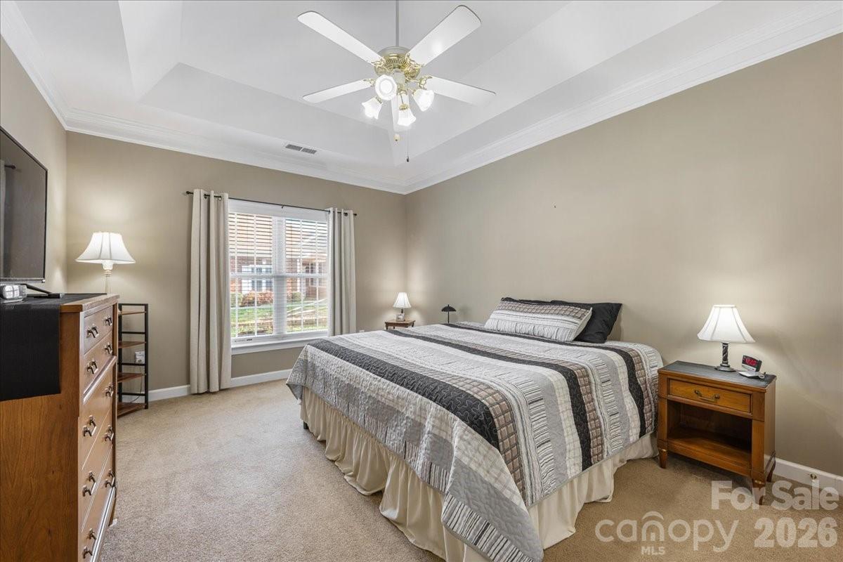 8368 Windsor Ridge Drive Charlotte, NC 28277 - Photo 25 of 46 a spacious bedroom with a bed and a chandelier