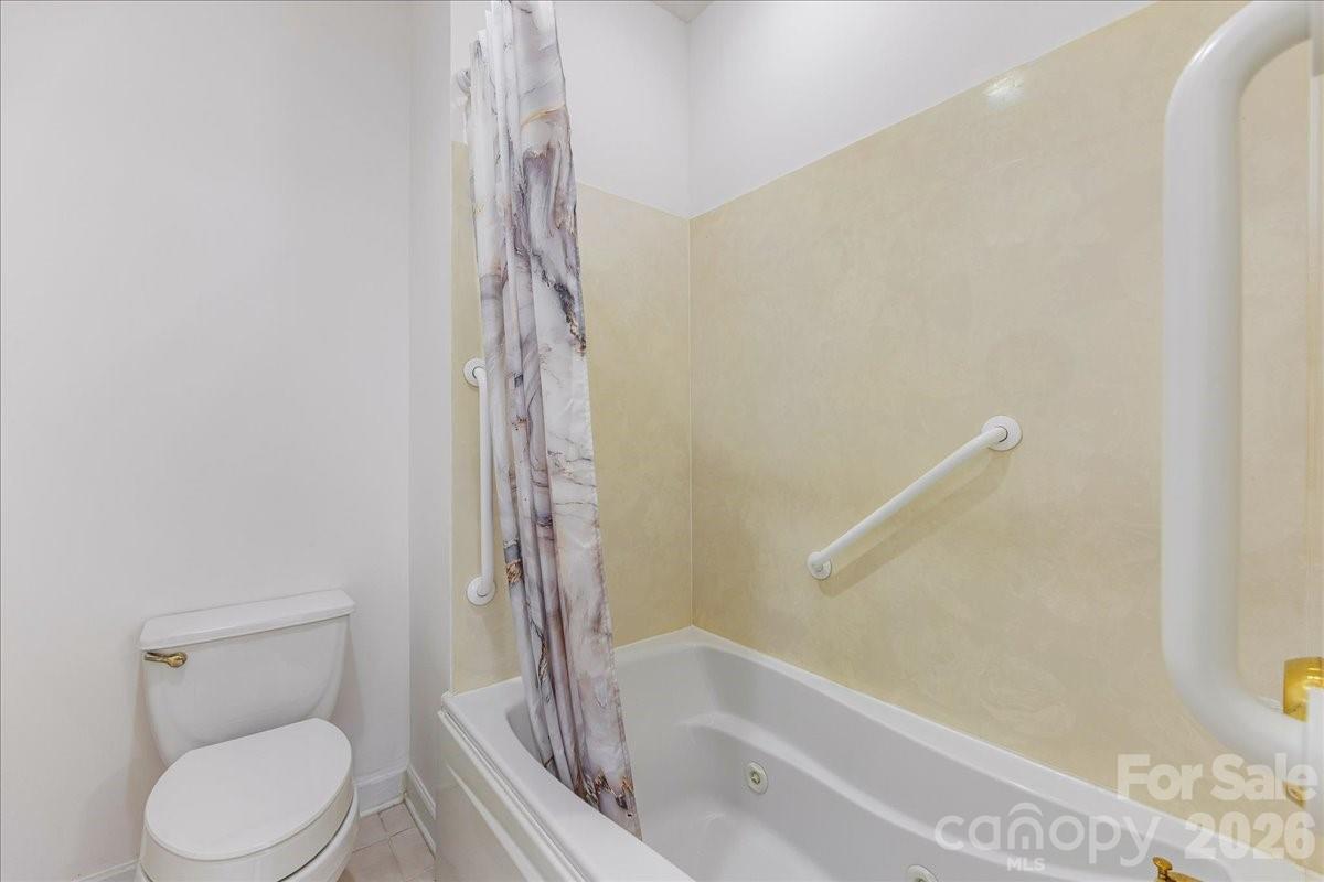 8368 Windsor Ridge Drive Charlotte, NC 28277 - Photo 28 of 46 a bathroom with a toilet and a bathtub