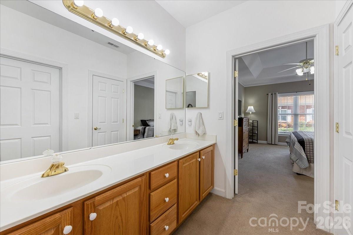 8368 Windsor Ridge Drive Charlotte, NC 28277 - Photo 29 of 46 a spacious en suite bathroom with a sink and a mirror