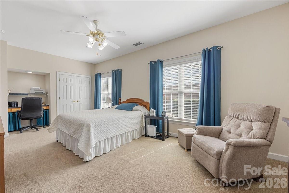 8368 Windsor Ridge Drive Charlotte, NC 28277 - Photo 30 of 46 a spacious bedroom with a bed and a chandelier