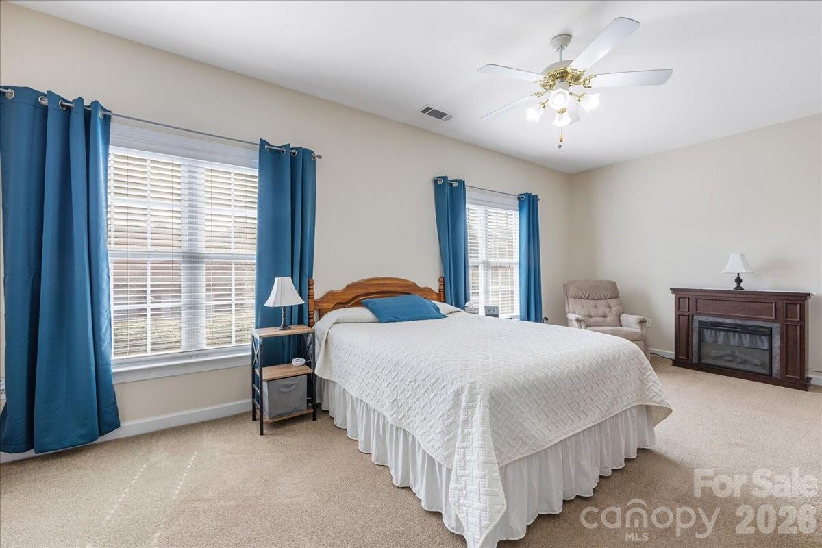 8368 Windsor Ridge Drive Charlotte, NC 28277 - Photo 33 of 46 a bedroom with bed and a chandelier