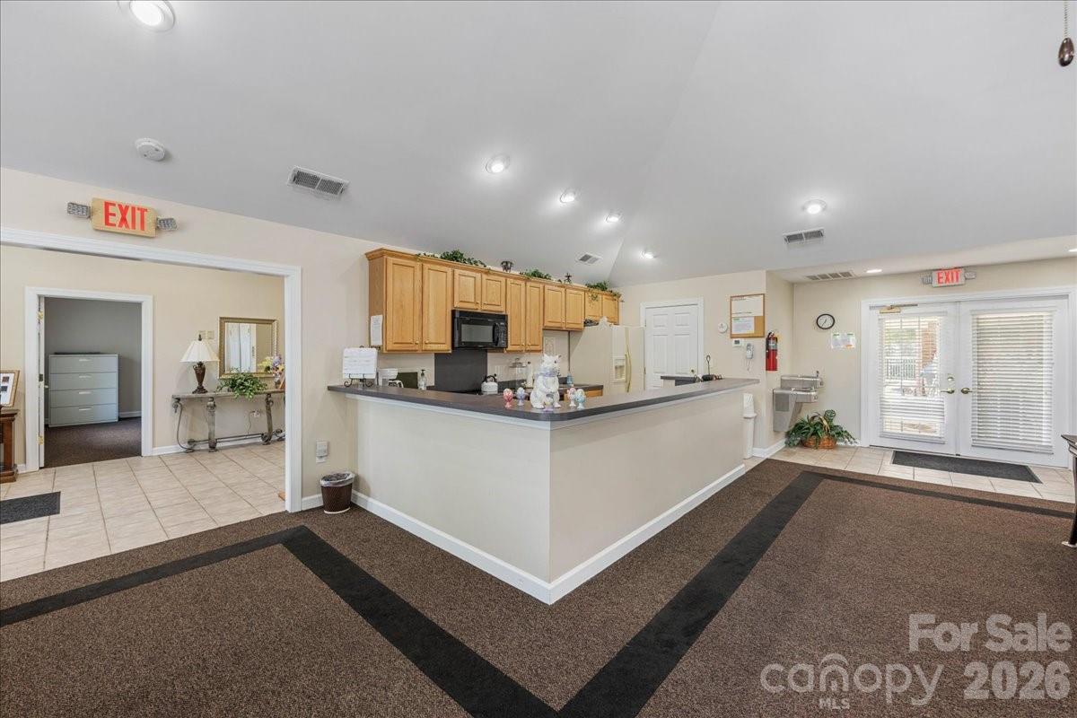 8368 Windsor Ridge Drive Charlotte, NC 28277 - Photo 38 of 46 a large white kitchen with kitchen island a large counter top and appliances