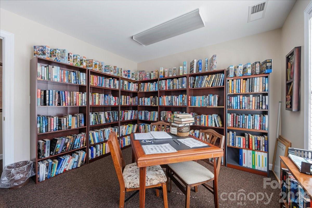 8368 Windsor Ridge Drive Charlotte, NC 28277 - Photo 43 of 46 a view of a work space with a book shelf and a window
