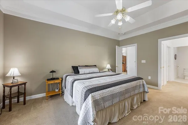 a spacious bedroom with a bed and a chandelier