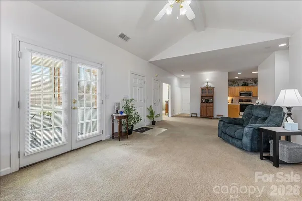 a living room with furniture and large windows