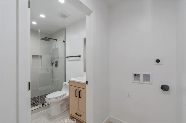 a bathroom with a toilet a sink and shower