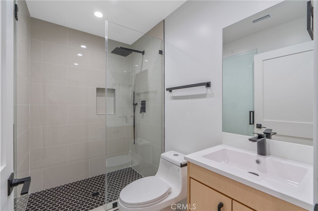 7439 Ranchito Avenue Van Nuys, CA 91405 - Photo 7 of 10 a bathroom with a sink toilet and shower