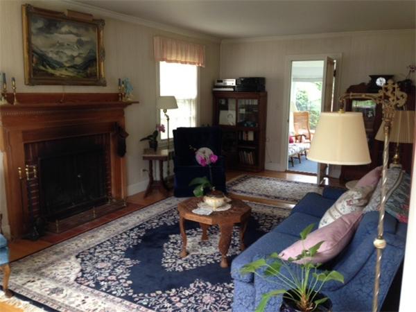 41 Longfellow Road Needham, MA 02494 - Photo 3 of 20 a living room with furniture a fireplace and wall paintings