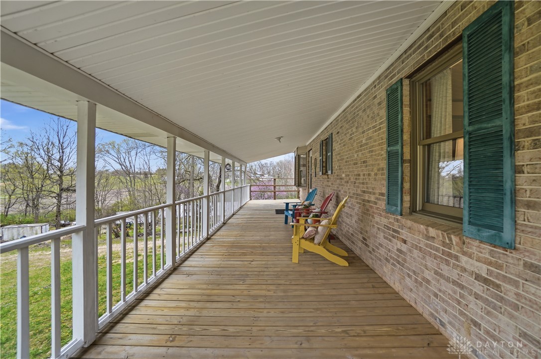 7553 Coffin Station Road Springfield, OH 45502 - Photo 84 of 95 This spacious porch features durable wood flooring and overlooks a serene, expansive landscape.