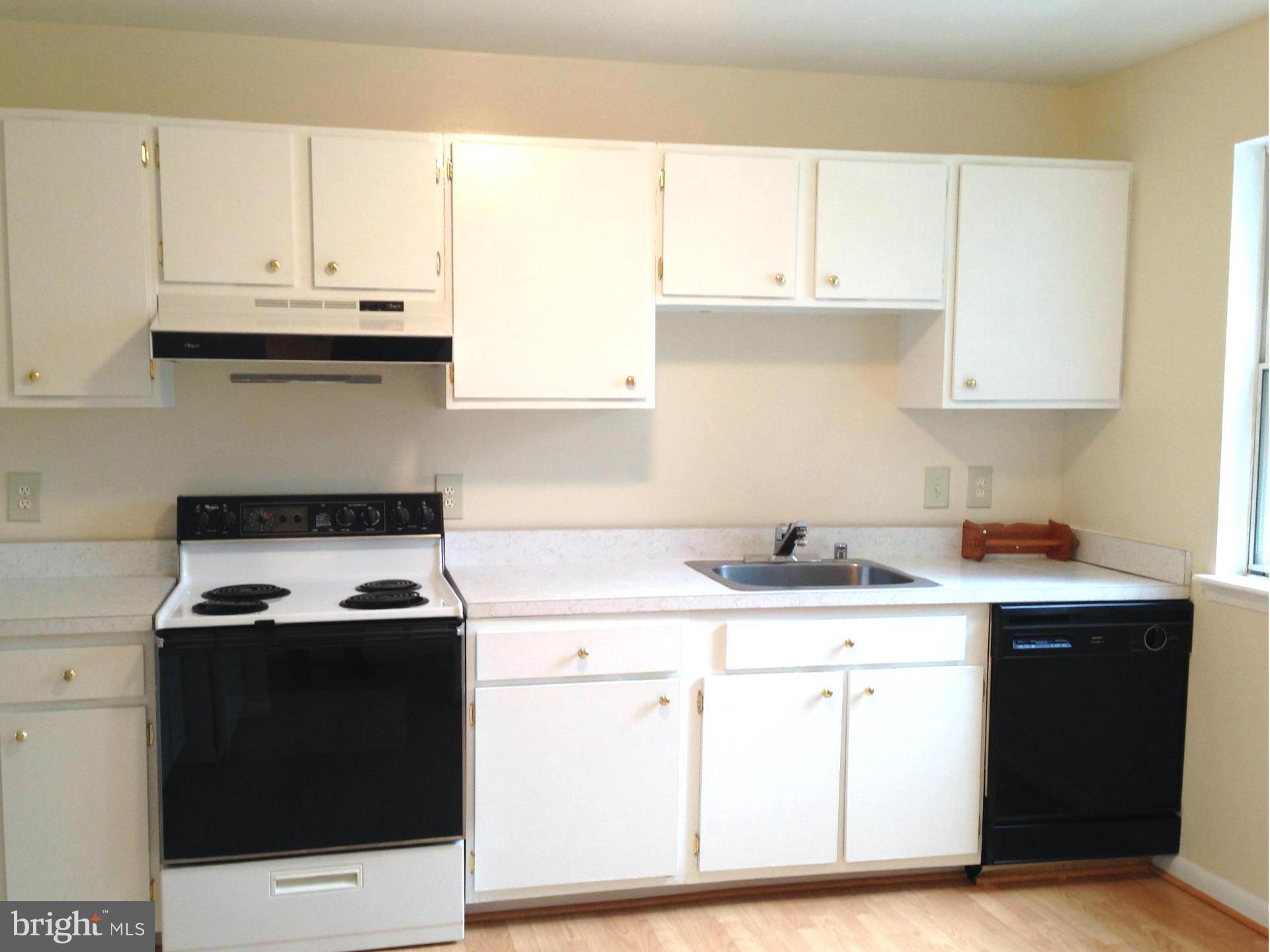 9325 Pan Ridge Road Baltimore, MD 21234 - Photo 2 of 20 a kitchen with granite countertop a stove sink and cabinets