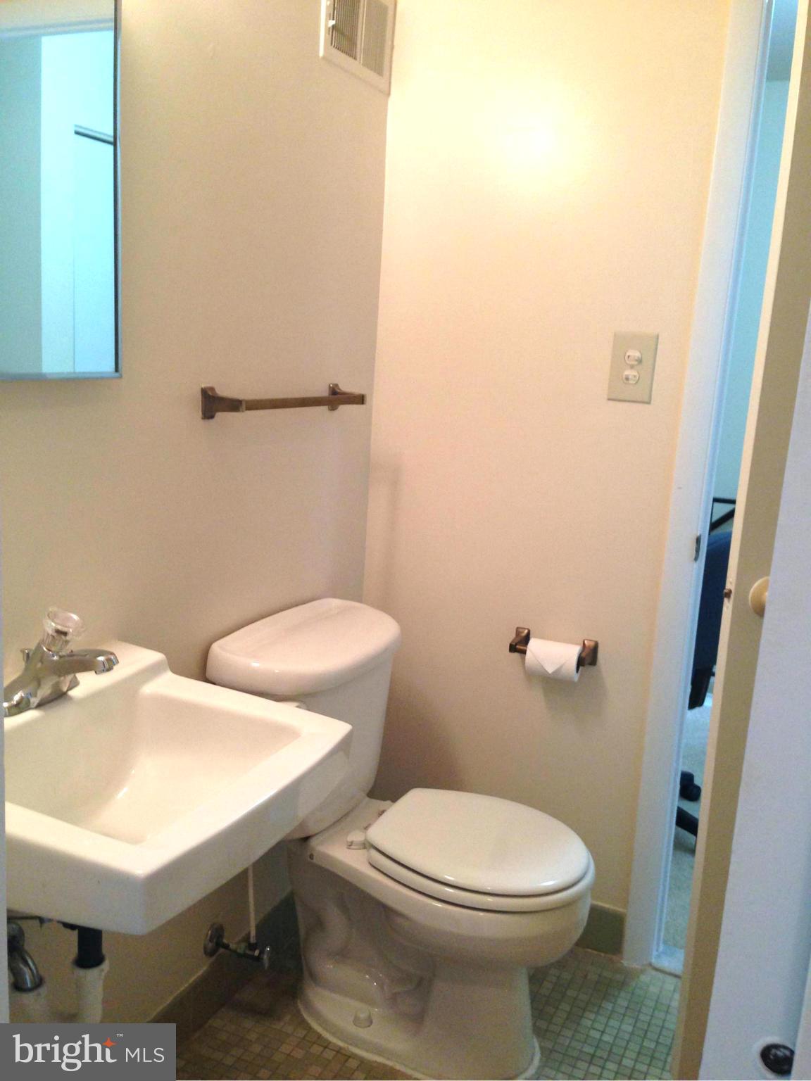 9325 Pan Ridge Road Baltimore, MD 21234 - Photo 13 of 20 a white toilet sitting next to a bathroom sink