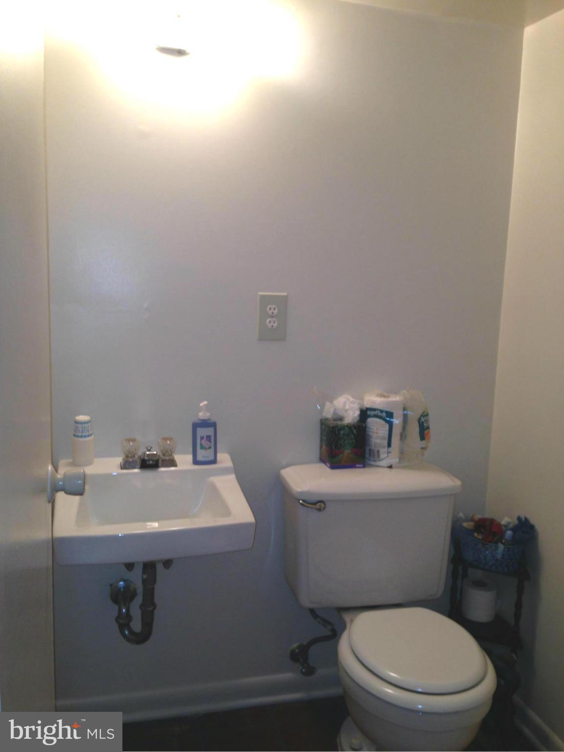 9325 Pan Ridge Road Baltimore, MD 21234 - Photo 19 of 20 a bathroom with a sink a toilet and a mirror