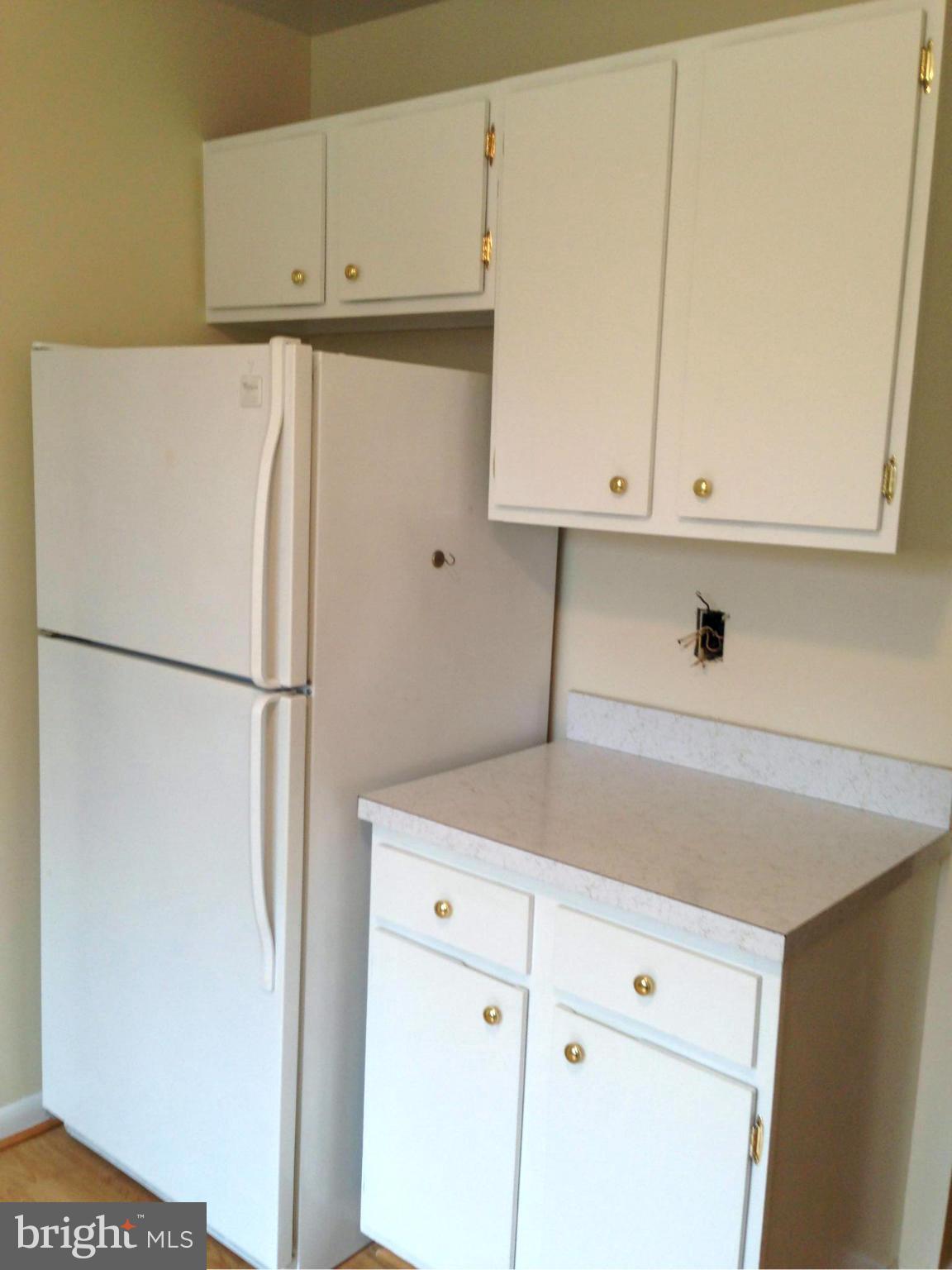 9325 Pan Ridge Road Baltimore, MD 21234 - Photo 3 of 20 a kitchen with cabinets and a refrigerator