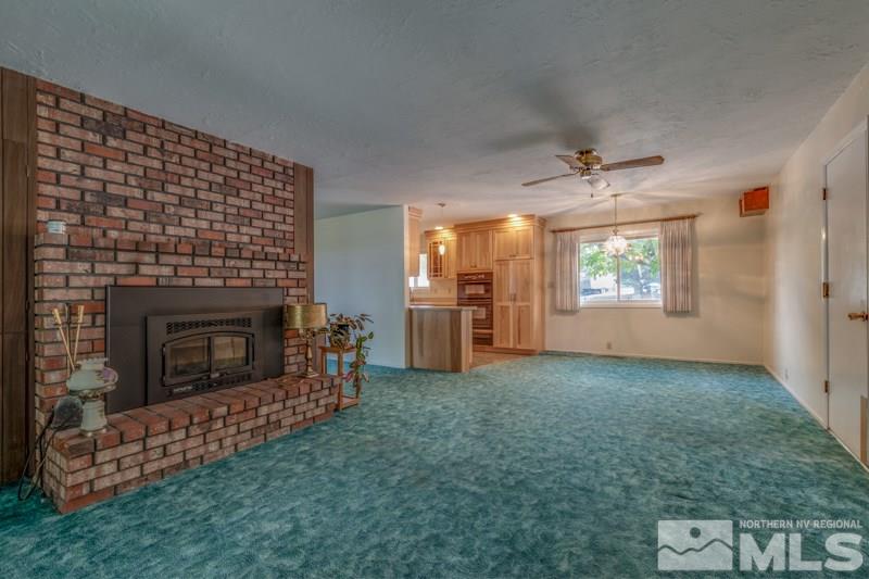 13935 Kewanna Trail Reno, NV 89521 - Photo 11 of 21 a view of a livingroom with a fireplace and window