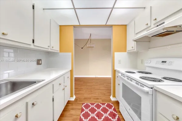 a kitchen with stainless steel appliances a stove a sink and a refrigerator