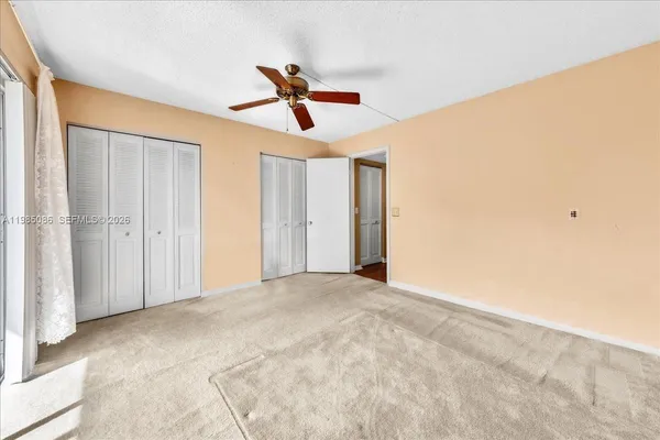 a view of empty room with ceiling fan