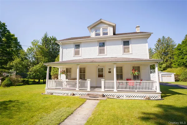 a front view of a house with a yard table and chairs