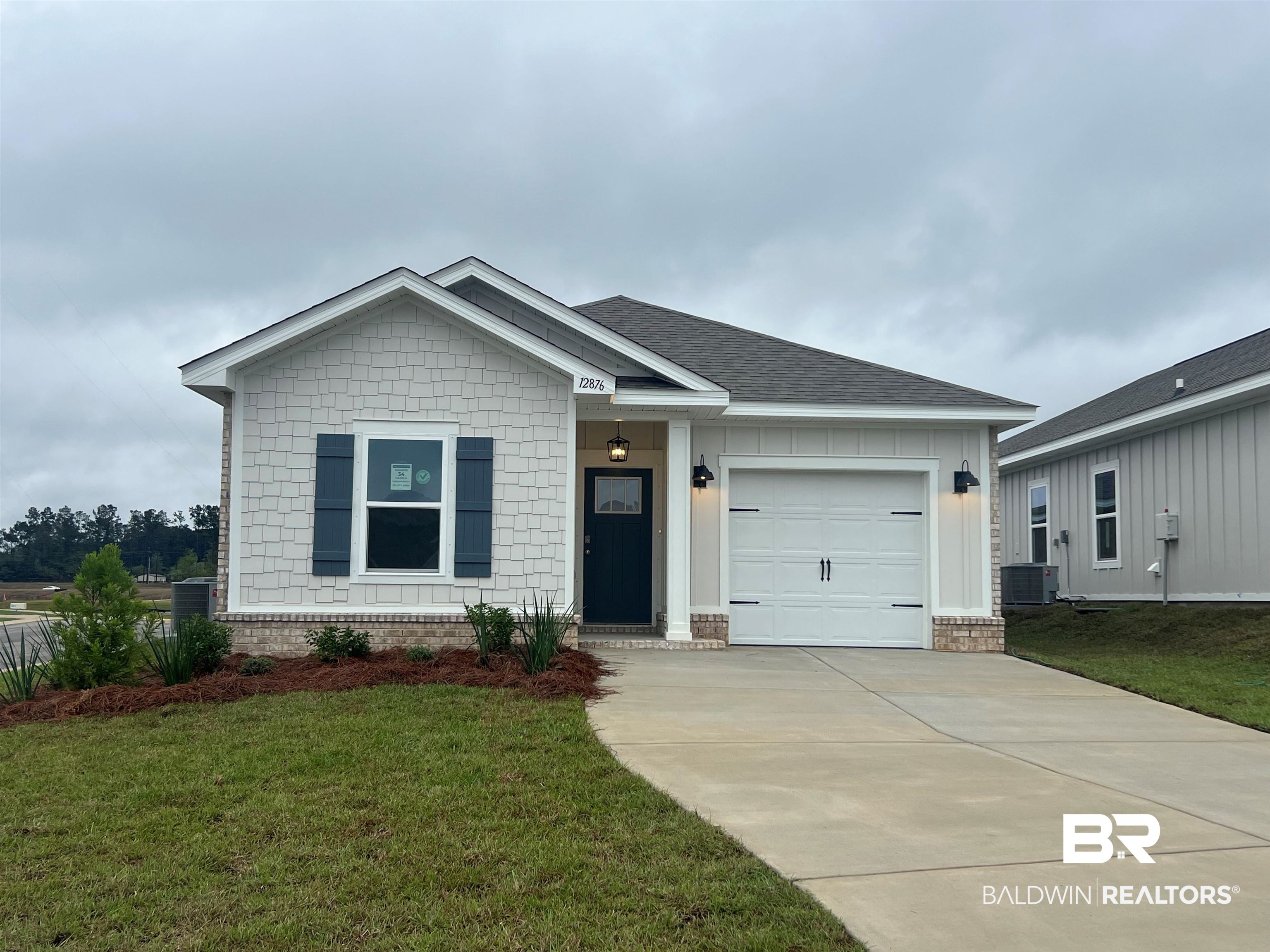 12876 Patriot Way Daphne, AL 36527 - Photo 1 of 33 View of front of home featuring a garage, a front lawn, and cooling unit