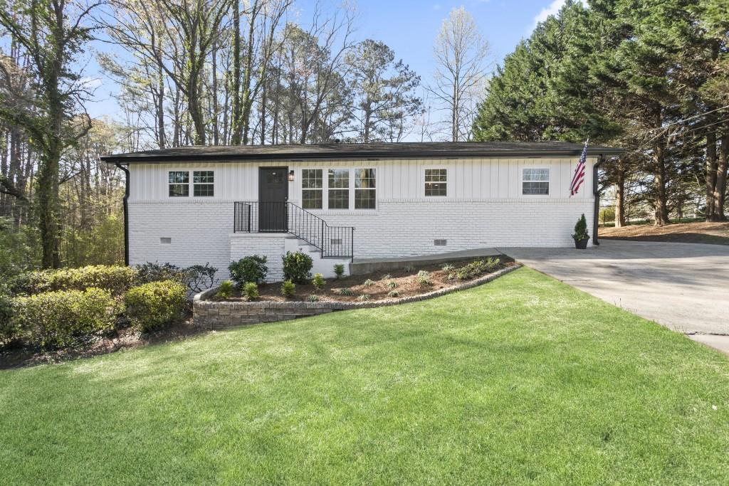 a view of a house with a yard and plants