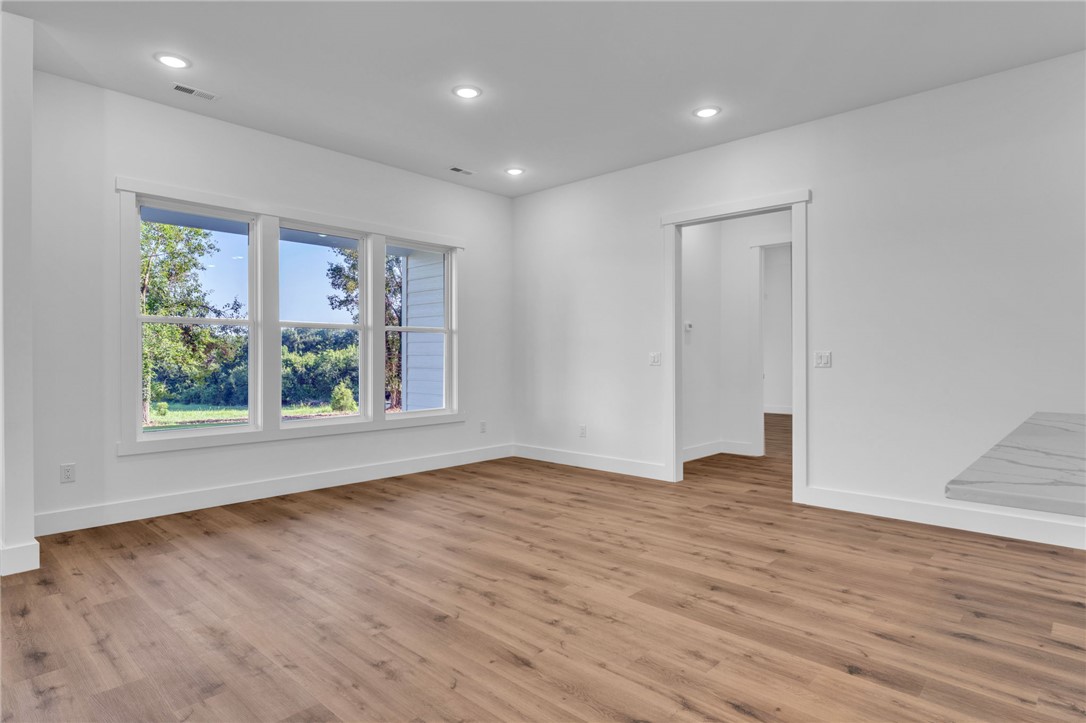 1727 Harris Bridge Road Anderson, SC 29621 - Photo 25 of 35 Natural light floods this inviting living area featuring rich wood-look flooring and clean architectural lines.