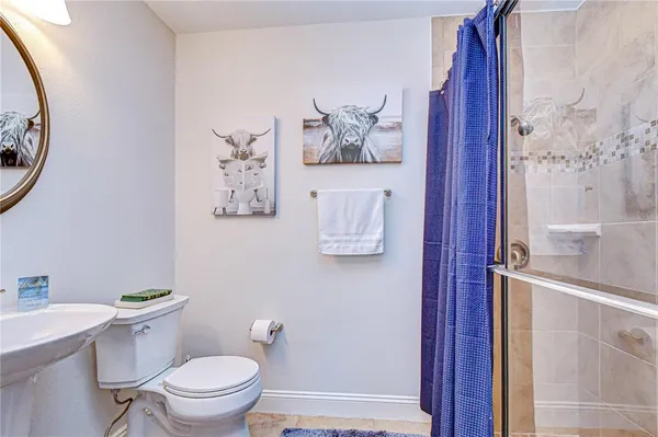 a large kitchen with stainless steel appliances granite countertop a stove top oven a sink a counter space and dining table