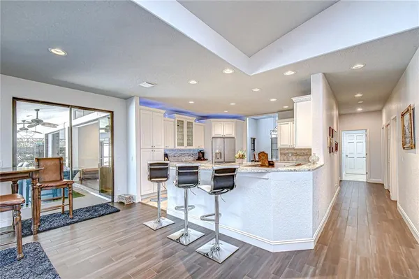 a kitchen with granite countertop stainless steel appliances sink stove microwave and cabinets